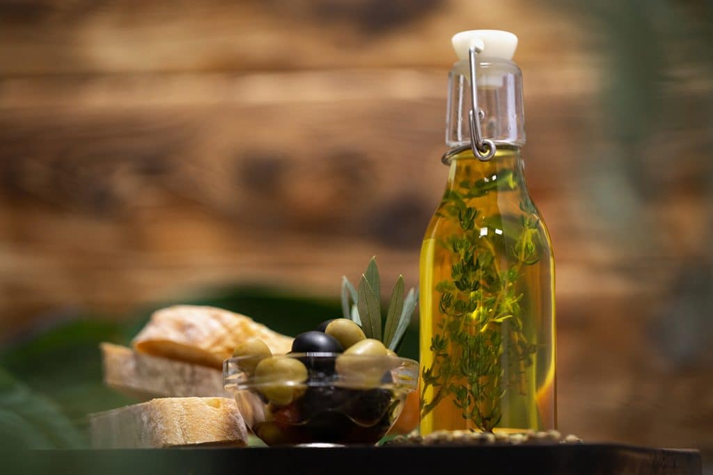 olives bottle olive oil wooden background